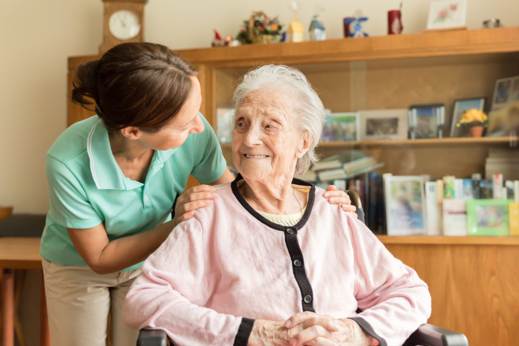Caregiver spending time with an older adult; shared stock placeholder