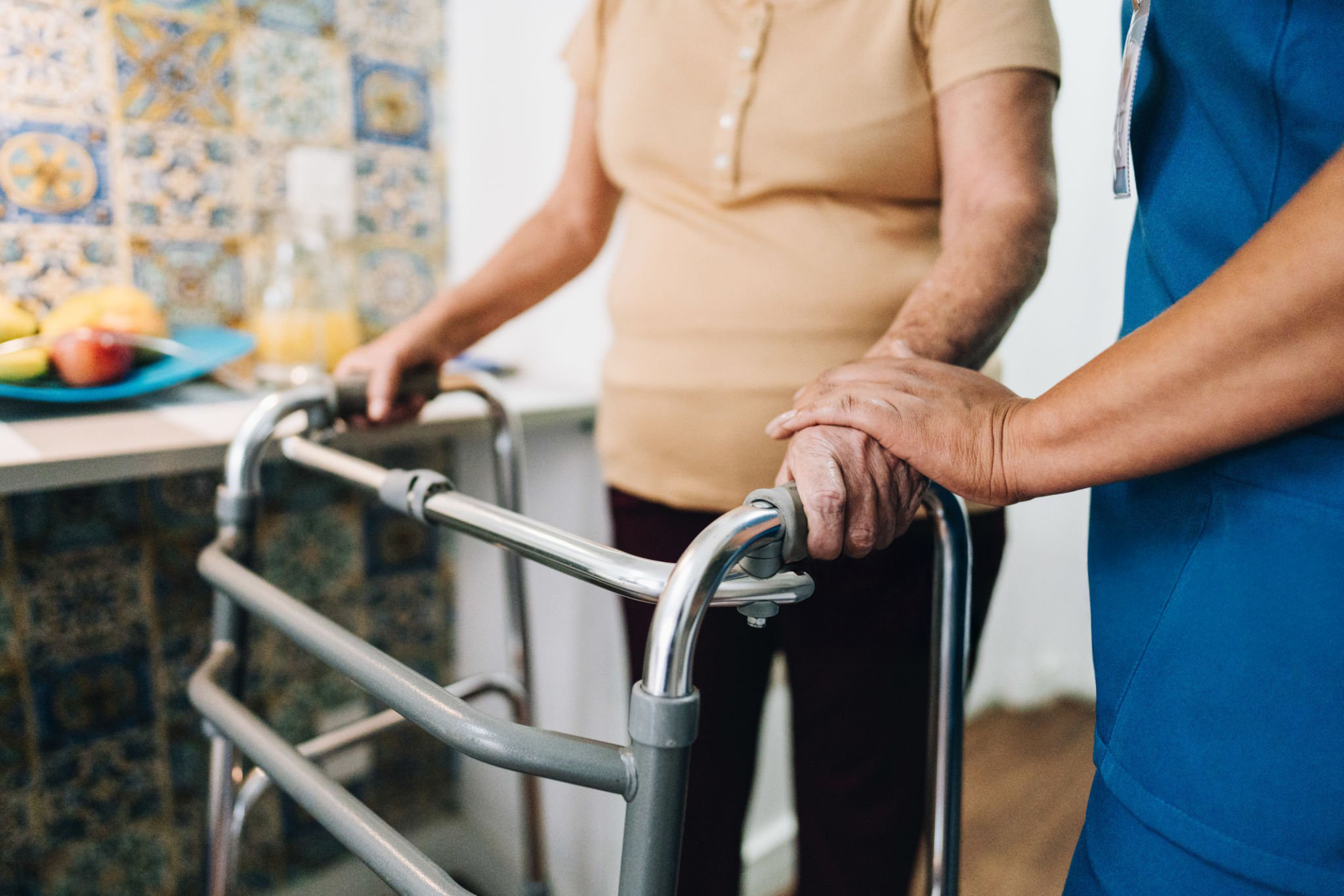 Caregiver supporting mobility; shared stock placeholder